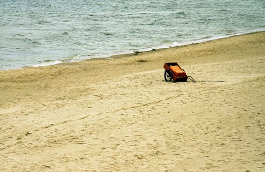 red cart on the empty beach