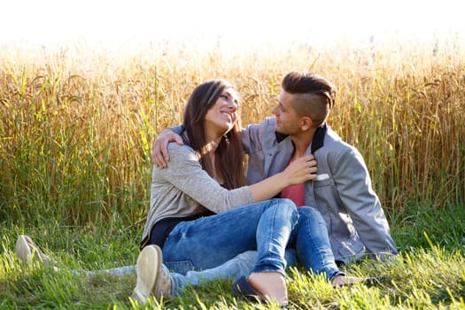 portrait of happy smiling young couple in love embracing outdoor at sunny day