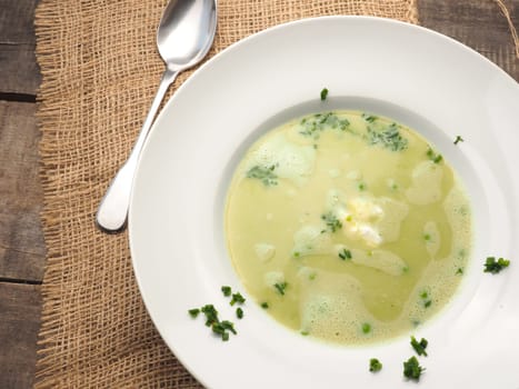 Cream soup of peas on a rustic wooden table