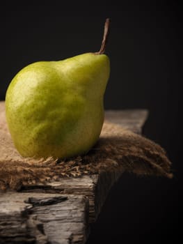 Fresh organic pear on an old wooden kitchen table