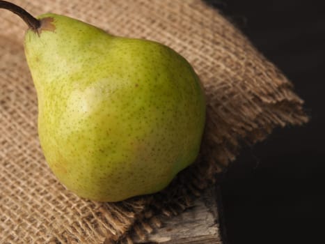 Fresh organic pear on an old wooden kitchen table