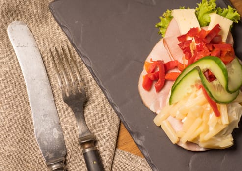 Danish specialties and national dishes, high-quality open sandwich. Sandwich with sliced ham, Mayonnaise Pickled peppers, asparagus and cucumbers served on a plate ready for eating