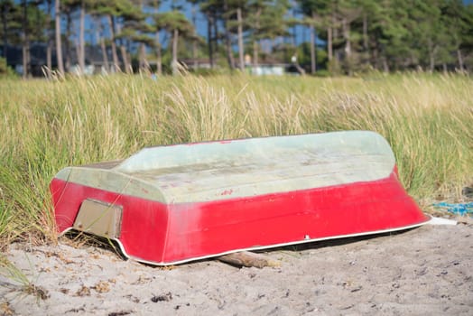small red fishing boat on a danish beach