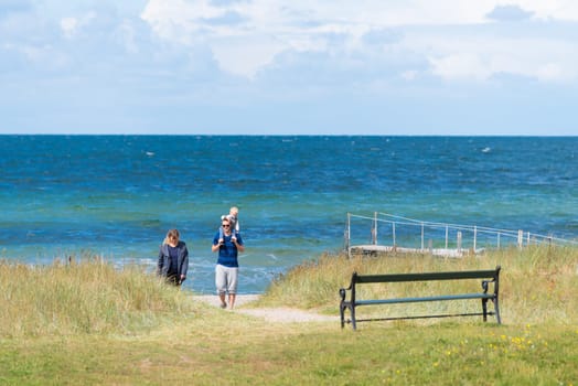 BJERGE, DENMARK - AUGUST 1, 2016: Unknown happy family on a danish beach