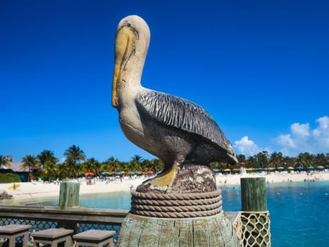 A pelican statue by the beach and ocean