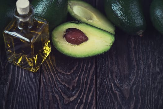 Oil of avocado on a dark wooden background