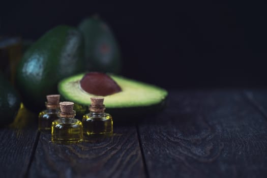 Oil of avocado on a dark wooden background