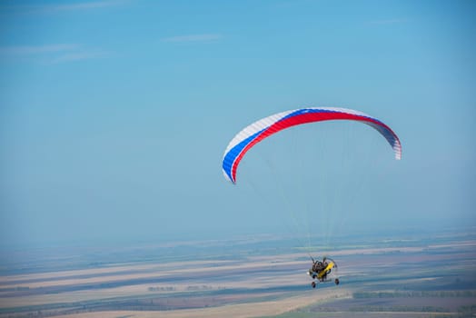 Paragliding in mountains. Para gliders in fight in the mountains, extreme sport activity.