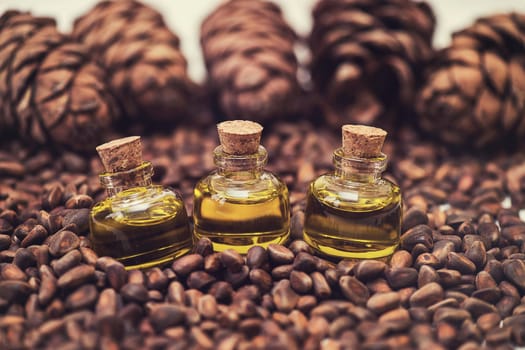 The cedar oil in a glass bottles on the cedar nuts