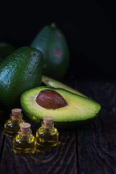 Oil of avocado on a dark wooden background