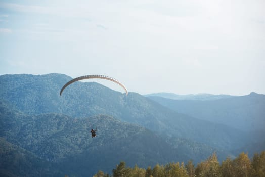 Paragliding in mountains. Para gliders in fight in the mountains, extreme sport activity.