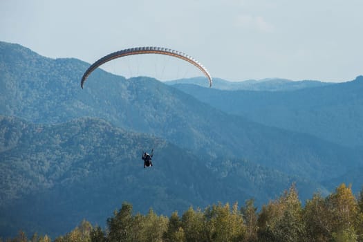 Paragliding in mountains. Para gliders in fight in the mountains, extreme sport activity.