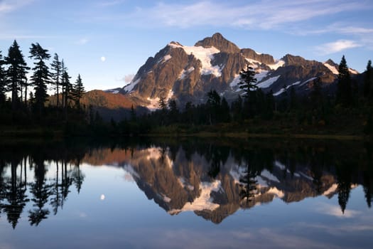 Light hits Mt Shuksan well at sunset above picture lake