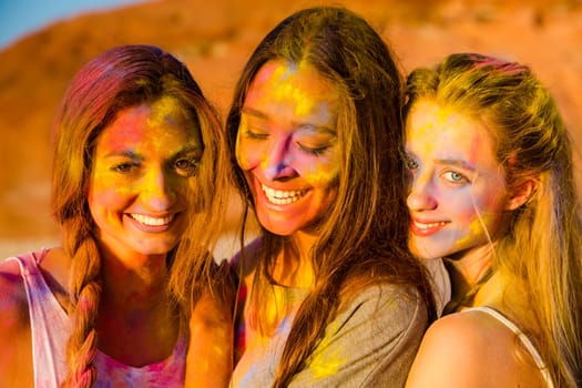 Best friends full of colored powder all over the body