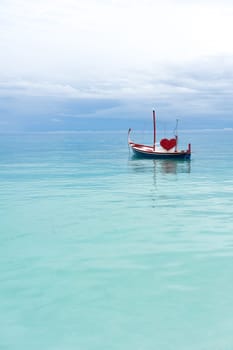 boat with red heart in the ocean