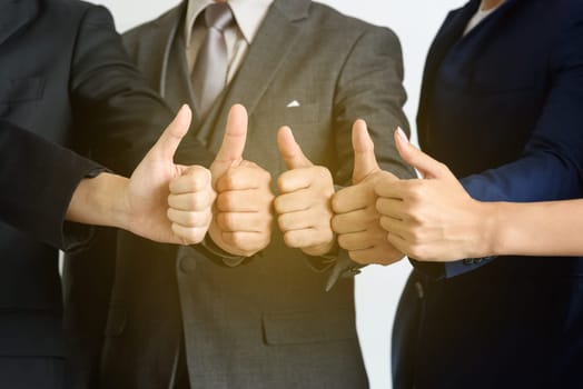 business teamwork show hands with thumb up, very good, successful concept, soft light effect
