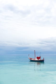 boat with red heart in the ocean
