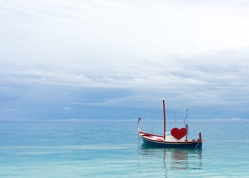 boat with red heart in the ocean
