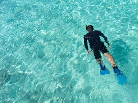 Young woman snorkeling in tropical water on vacation