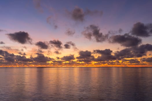 Colorful sunrise over tropical ocean on Maldives