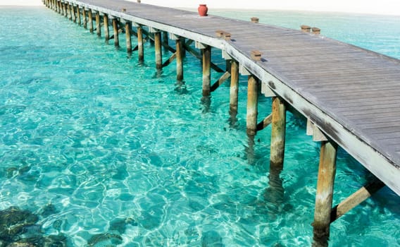 Wooden floor with seascape and blue sky background