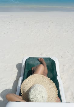 Woman in relaxation on tropical beach in holiday