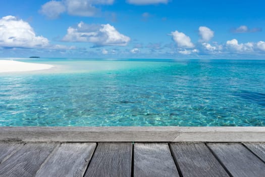 Wooden floor with seascape and blue sky background