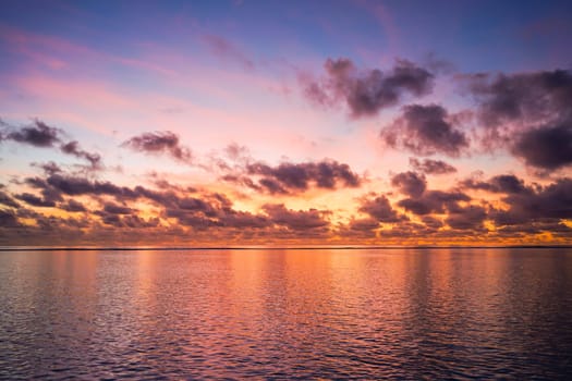 Colorful sunrise over tropical ocean on Maldives