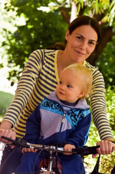 Mother and son on bicycle in the  nature.