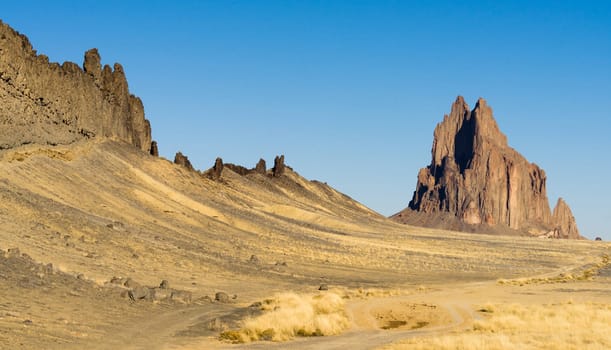 Blue skies appear in a panoramic view of Shiprock