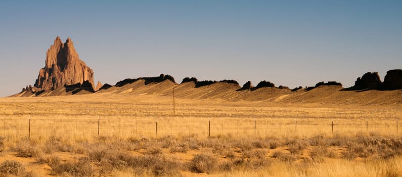 Blue skies appear in a panoramic view of Shiprock