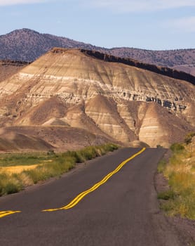 The road winds through colorful mineral and rock deposits in Oregon