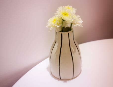 White Flowers Vase Decorated On Table, stock photo