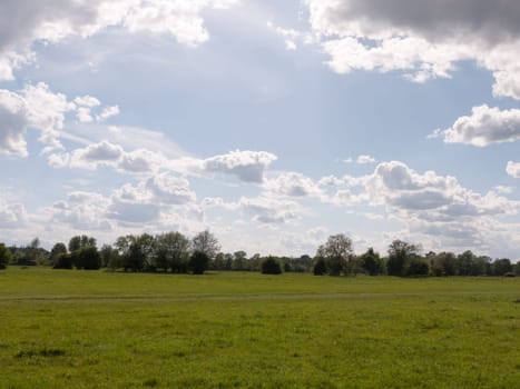 a walking path through an open countryside in the heartland of constable country essex england in the uk with no people and a clear sky on a summer afternoon heavenly