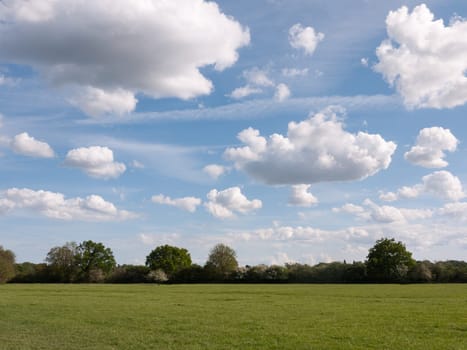 a walking path through an open countryside in the heartland of constable country essex england in the uk with no people and a clear sky on a summer afternoon heavenly grace