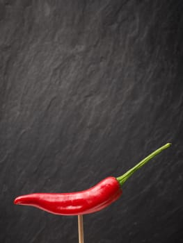 Close up of a red hot pepperoni, spicy ingredients, space for text
