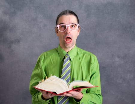 angry lawyer in green shirt and necktie with statute book and pink glasses