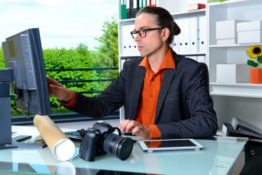 young reporter working in editorial office with computer