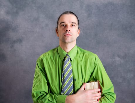 young lawyer in green shirt and necktie with statute book