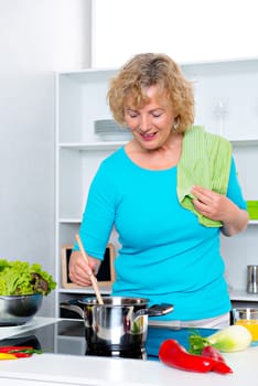 blond woman cooking in a white kitchen