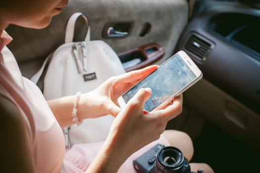 girl with red hair sitting in the car, to make payments for online purchases from your device using a bank debit card. online payments, bank transfers.