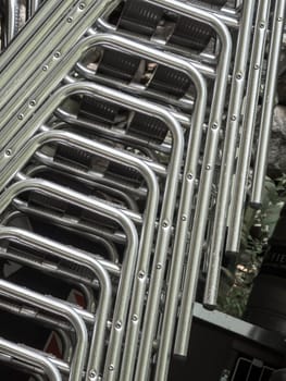 Detailed view of stacked chairs with metal frame.