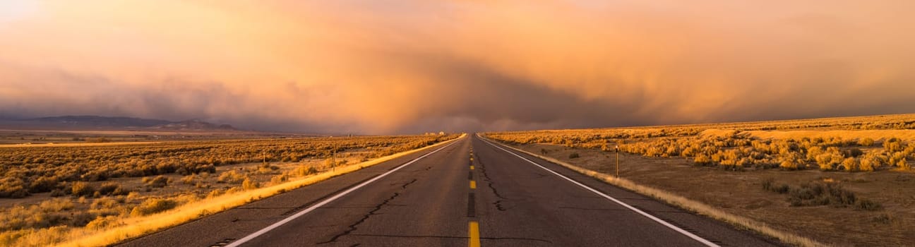 There are dramatic storm clouds ahead on this rural road