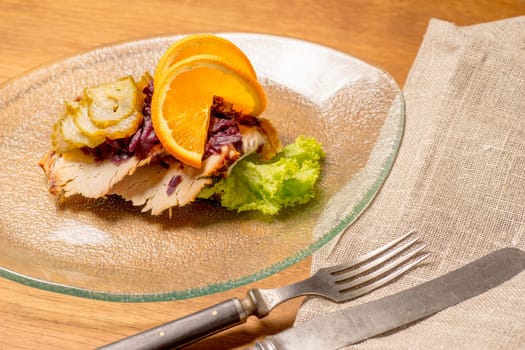 Danish specialties and national dishes, high-quality open sandwich. Roasted Pork belly and Pickled red cabbage and orange served on a plate and ready for eating
