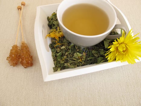 Herbal tea with calendula and cornflower on a tray