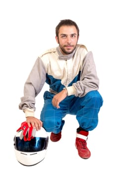 Racing driver posing with helmet isolated in white