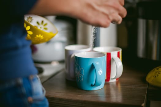 man making coffee. a married man with a ring on her finger, brew your morning coffee at breakfast for her family, three cups of coffee beverage