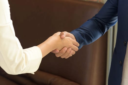 Business people shaking hands after closing deal in office, partnership merger and acquisition concept