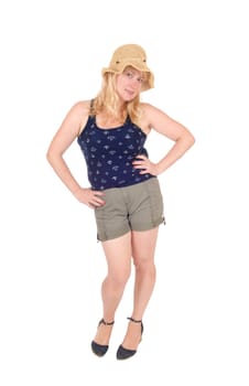 A blond woman in her thirties standing in shorts and a straw hat.isolated for white background..