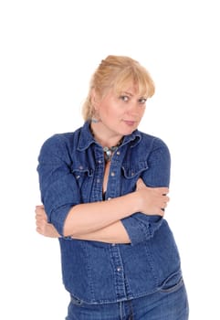 A beautiful blond woman standing in a jeans jacket with her arms.crossed, isolated for white background..